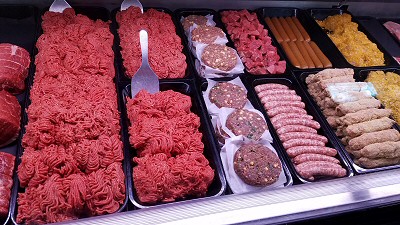 Display case with a wide variety of quality meat at Bessey's