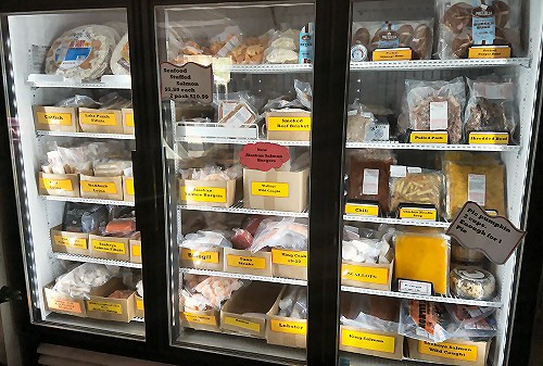 A variety of Bessey's seafood and fish options in a cooler
